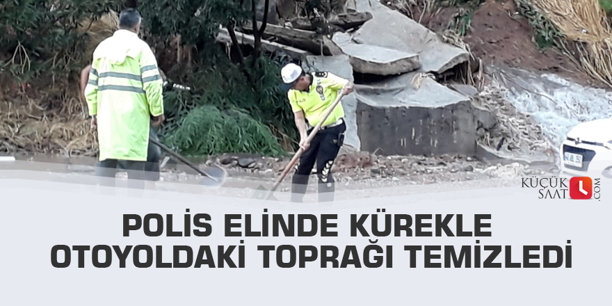 Polis elinde kürekle otoyoldaki toprağı temizledi